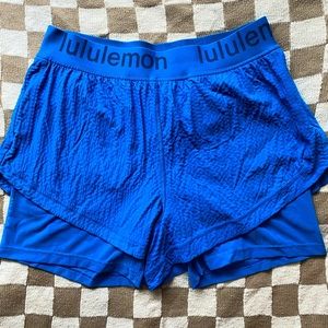 Lululemon logo waistband high-rise training short with zipper pockets .